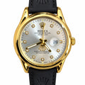Men's Gold-Tone Date Watch – Silver Dial & Black Strap. Gold-tone round case, silver sunburst dial, crystal-look markers, magnified date window, and black leather-look strap.