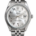 Men's Silver-Tone Fluted Bezel Date Watch – Arabic-Style Numeral Dial. Silver-tone fluted bezel, sunburst silver dial, decorative Arabic-style numeral markers, magnified date window, and metal-link bracelet.